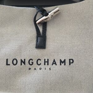 Longchamp Beige Canvas Crossbody with Black Trim and Silver Hardware.
